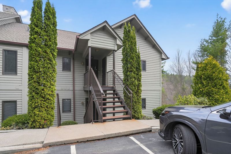 Exterior of the Blue Ridge Building at Chetola Resort in Blowing Rock, NC, with tall evergreens