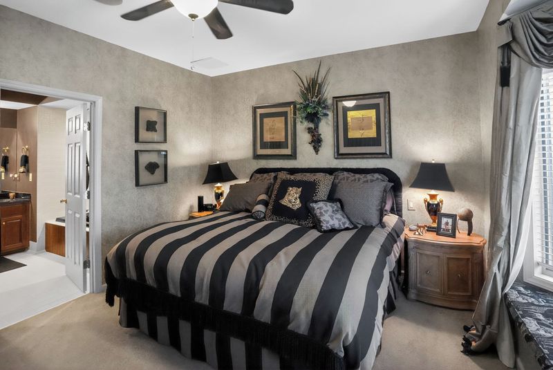 King suite with bold striped bedding and an ensuite bath