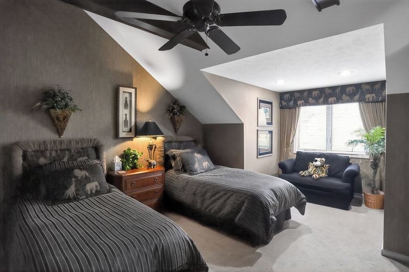 Guest bedroom with two twin beds and a loveseat
