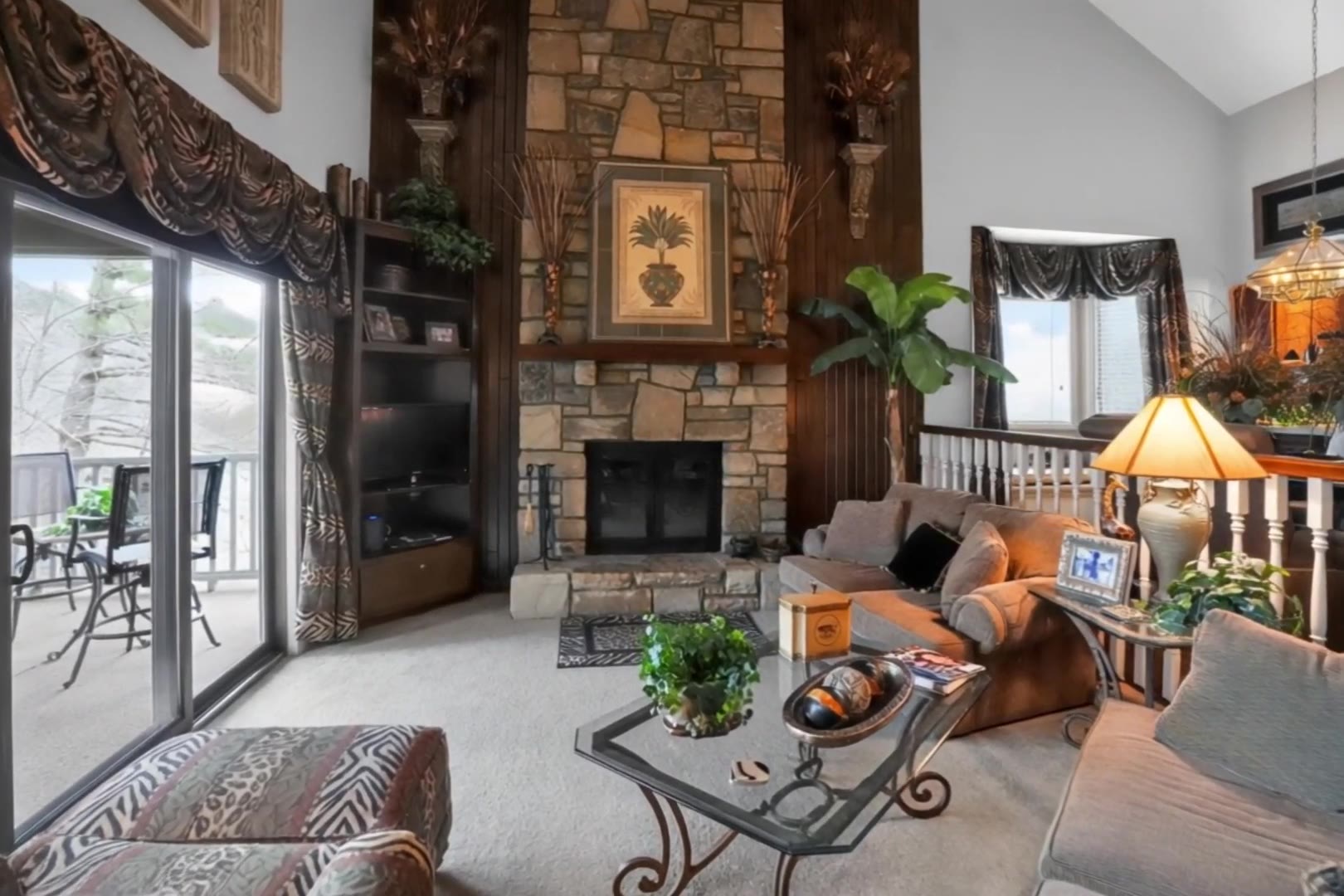 Floor-to-ceiling stone wood-burning fireplace and vaulted living room at The Jungle House, Chetola Resort